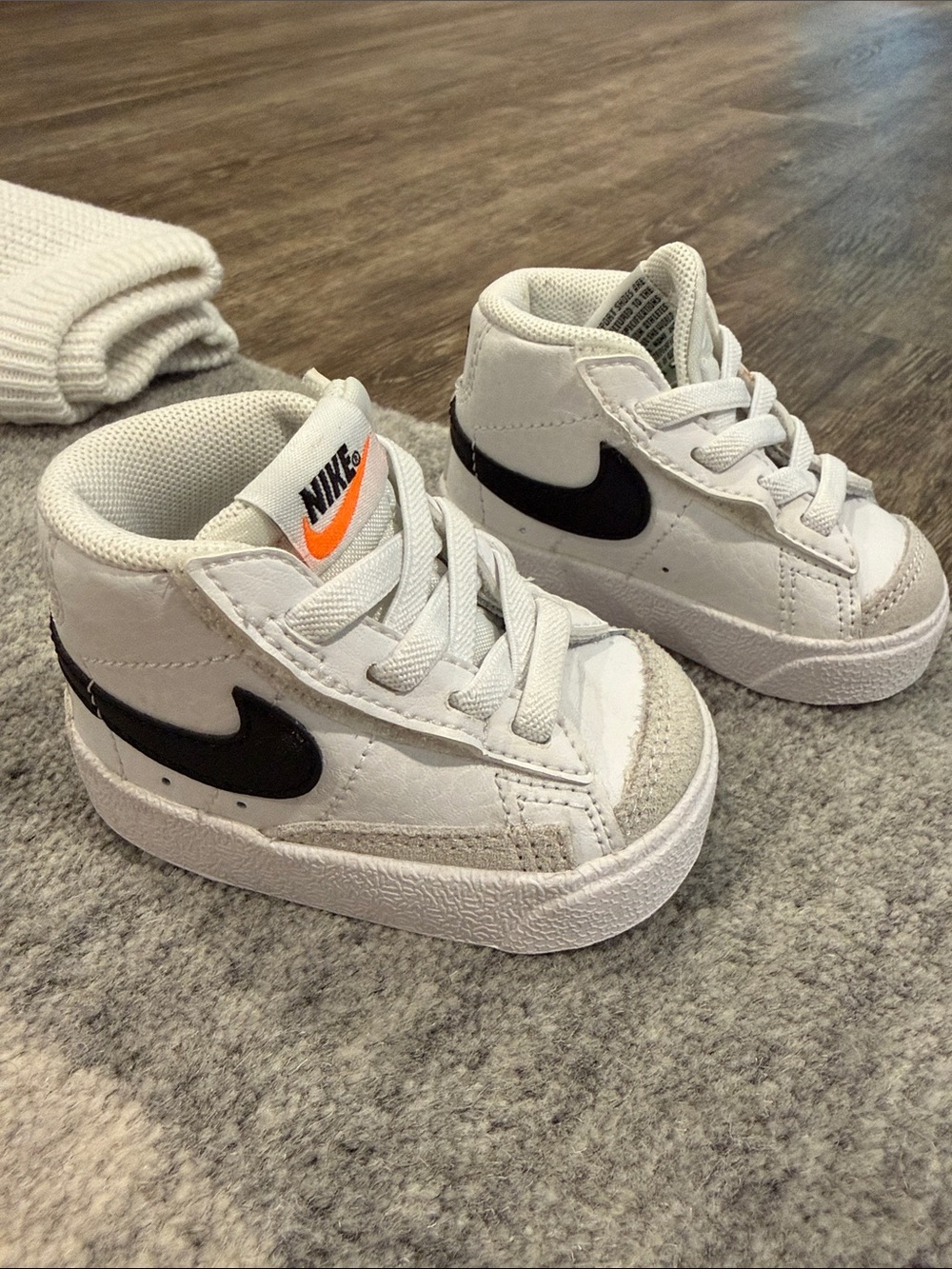 Nike Kids White High-Top Sneakers with Black Swoosh and Orange Logo
